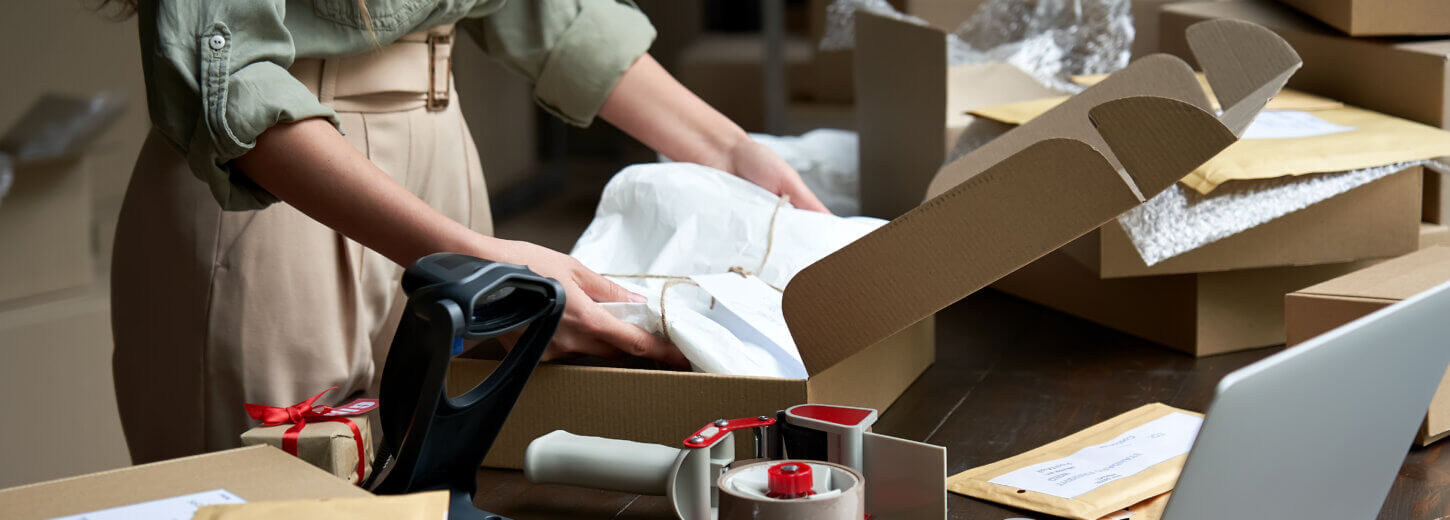 A woman packing a box for her business.